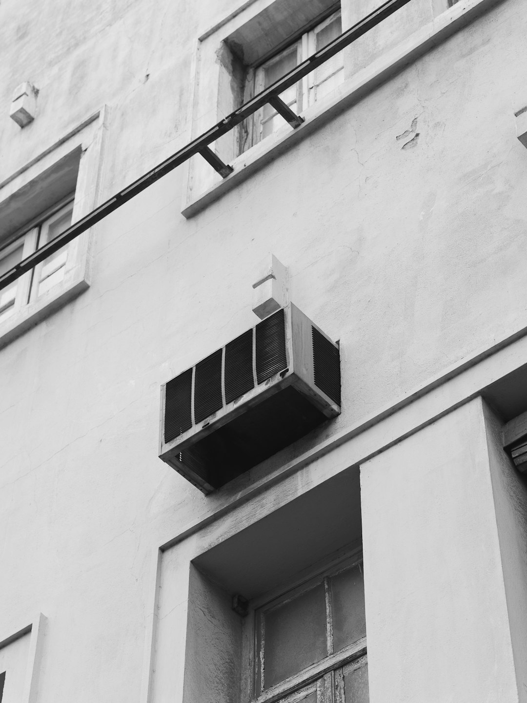 Window air conditioner attached to an old building.