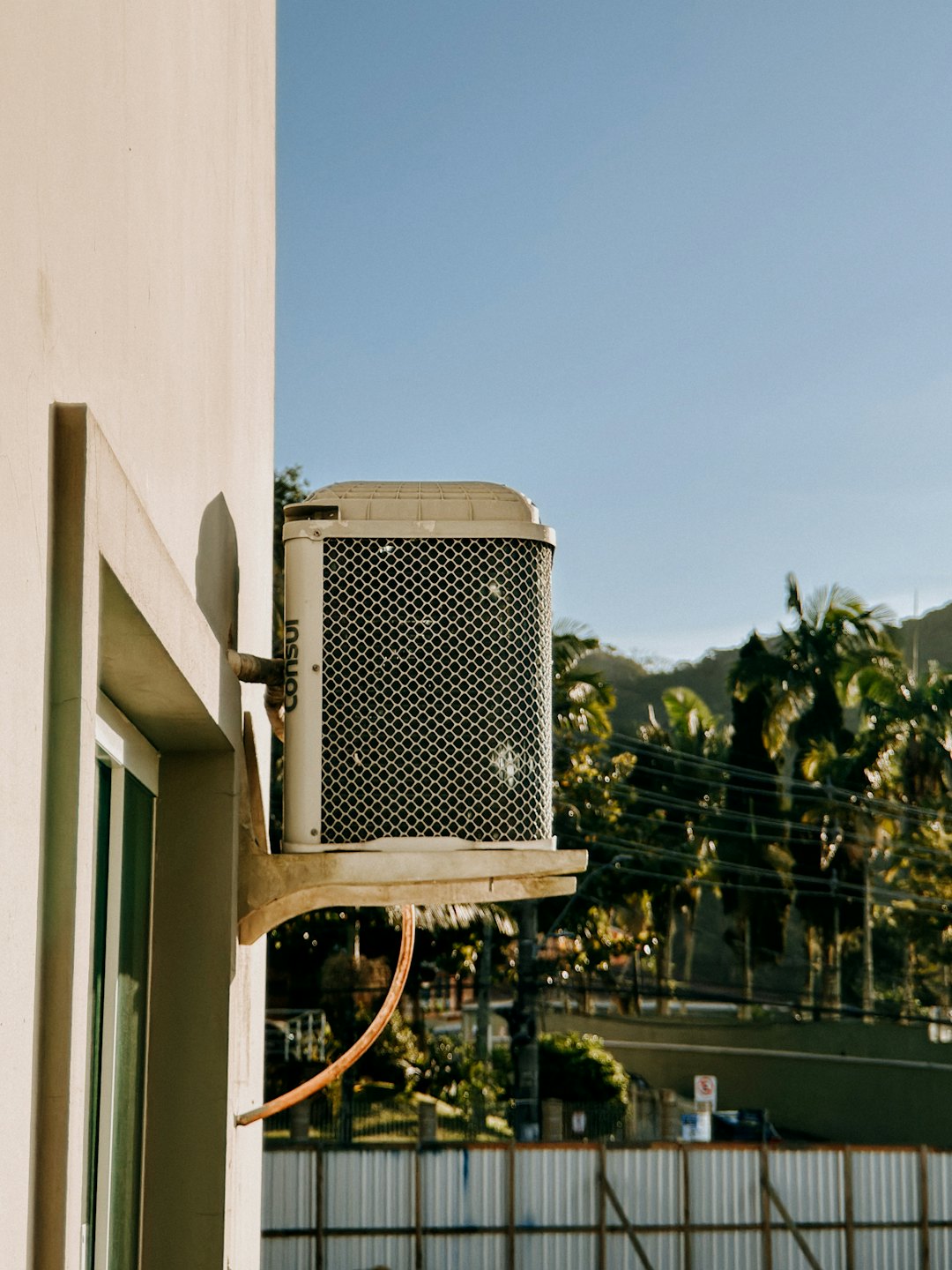 Outdoor air conditioning unit mounted on a building side.